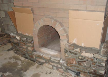 Fresh stone masonry facing a masonry fireplace.